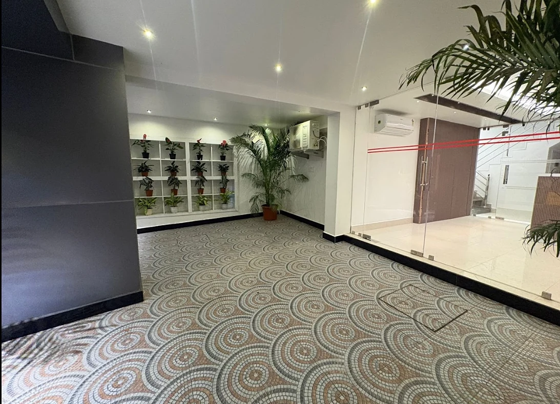 Entrance lobby with planters and a patterned mosaic floor