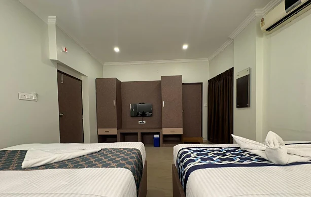 Triple Bed room with wall-mounted TV
